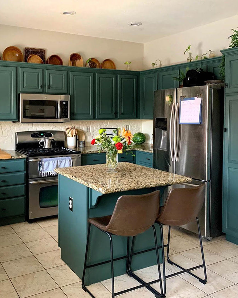 A fresh coat of dark green paint — Current Mood by Clare — totally transformed this kitchen. See the entire process and learn how to paint cabinets now on our blog!