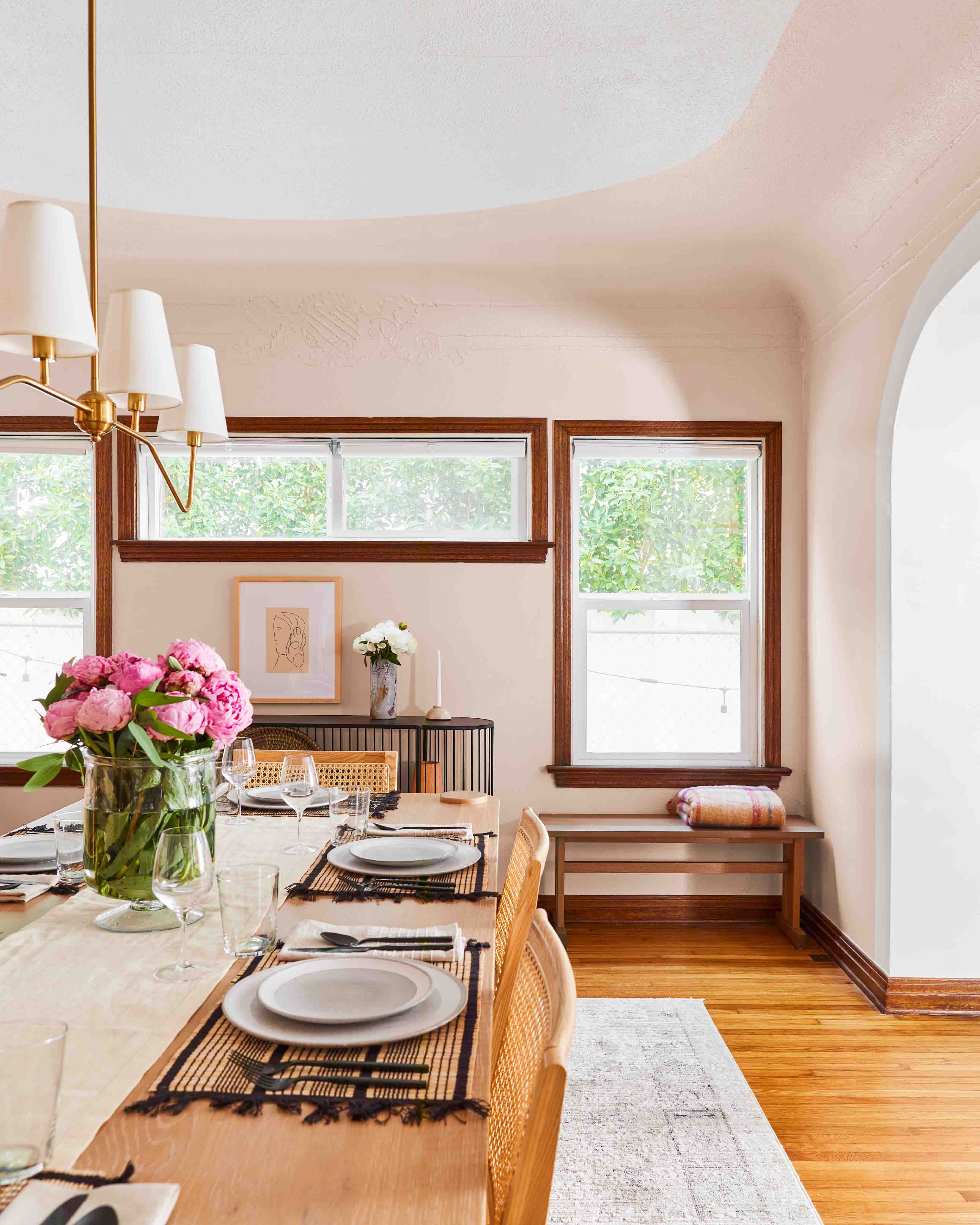 Blush pink wins best dining room color in this space, especially when mixed with light wood tones.