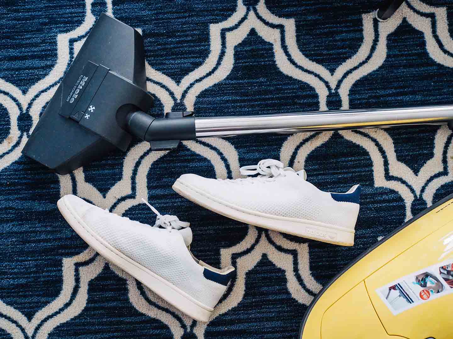healthier home vacuum and shoes on blue carpet 