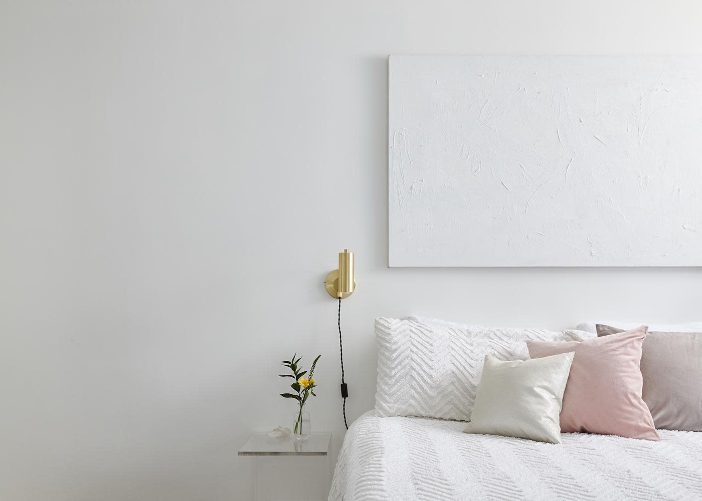 This stylish all-white bedroom makeover combines little luxuries and minimalist decor to create the ultimate bedroom retreat. See inside this dreamy space.