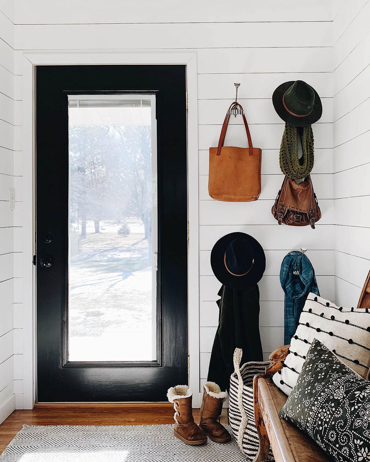 A bold door pained in Blackest by Clare is the perfect contrast for all-white walls. This stunning home is a lesson in how to make shades of white paint work in every room in your home.