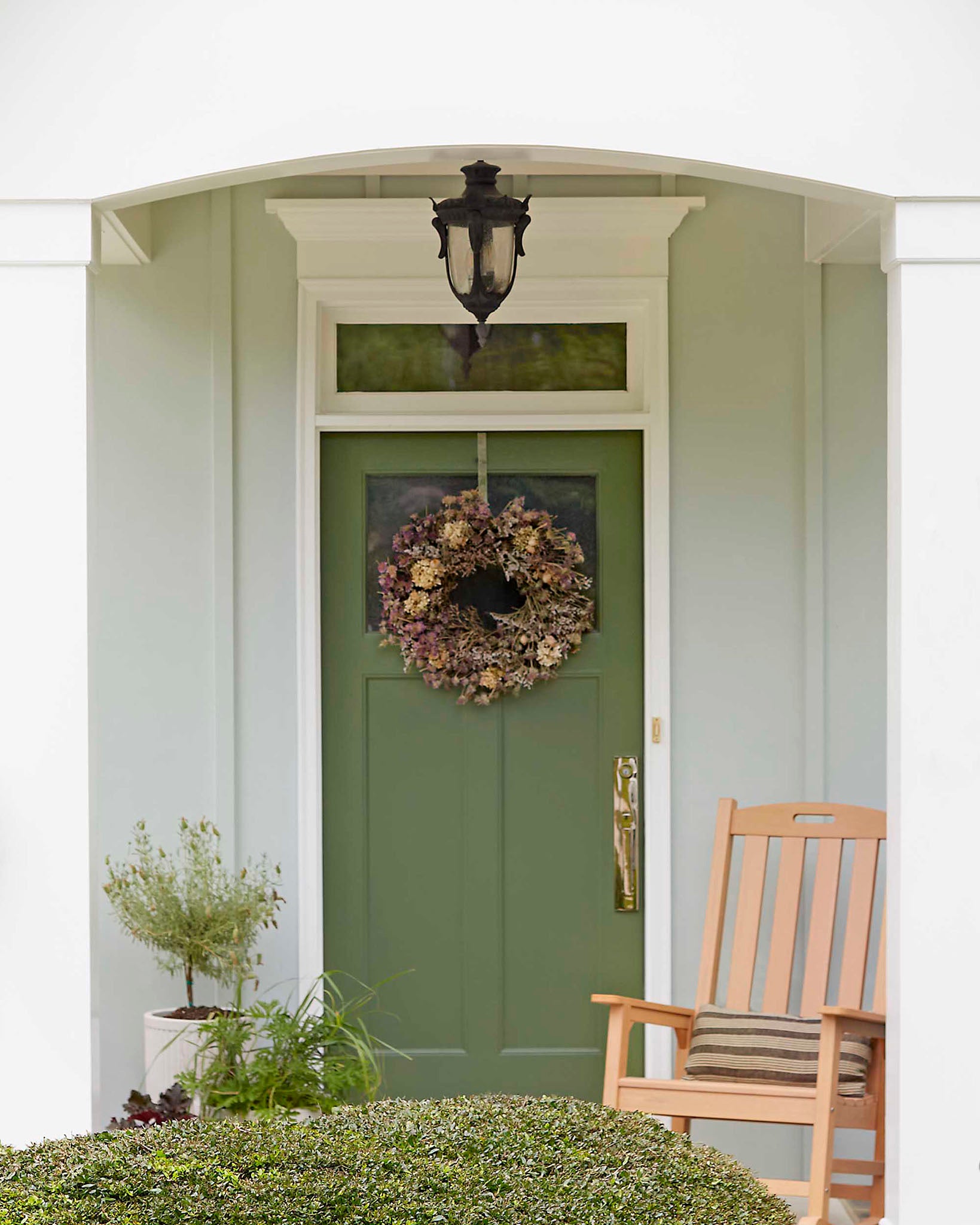 Exterior front door featuring Daily Greens, a green paint color by Clare