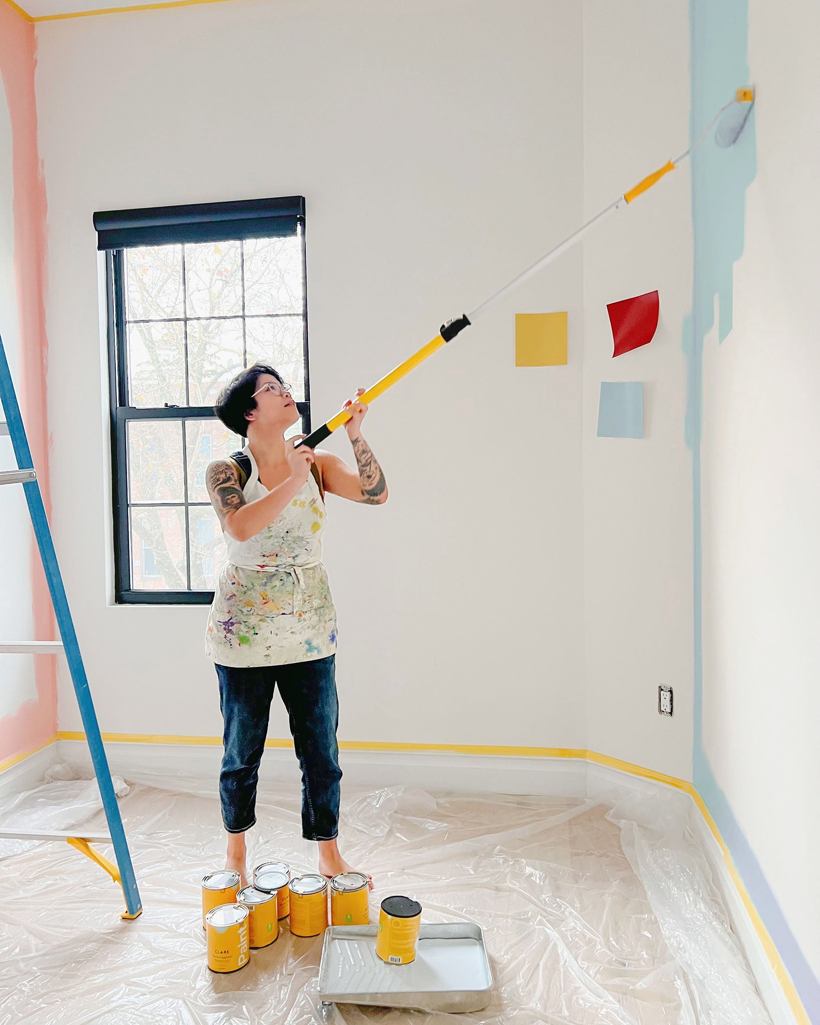 Clare Collective ambassador Lauren Hom painting a colorful room idea with Clare paint and supplies.