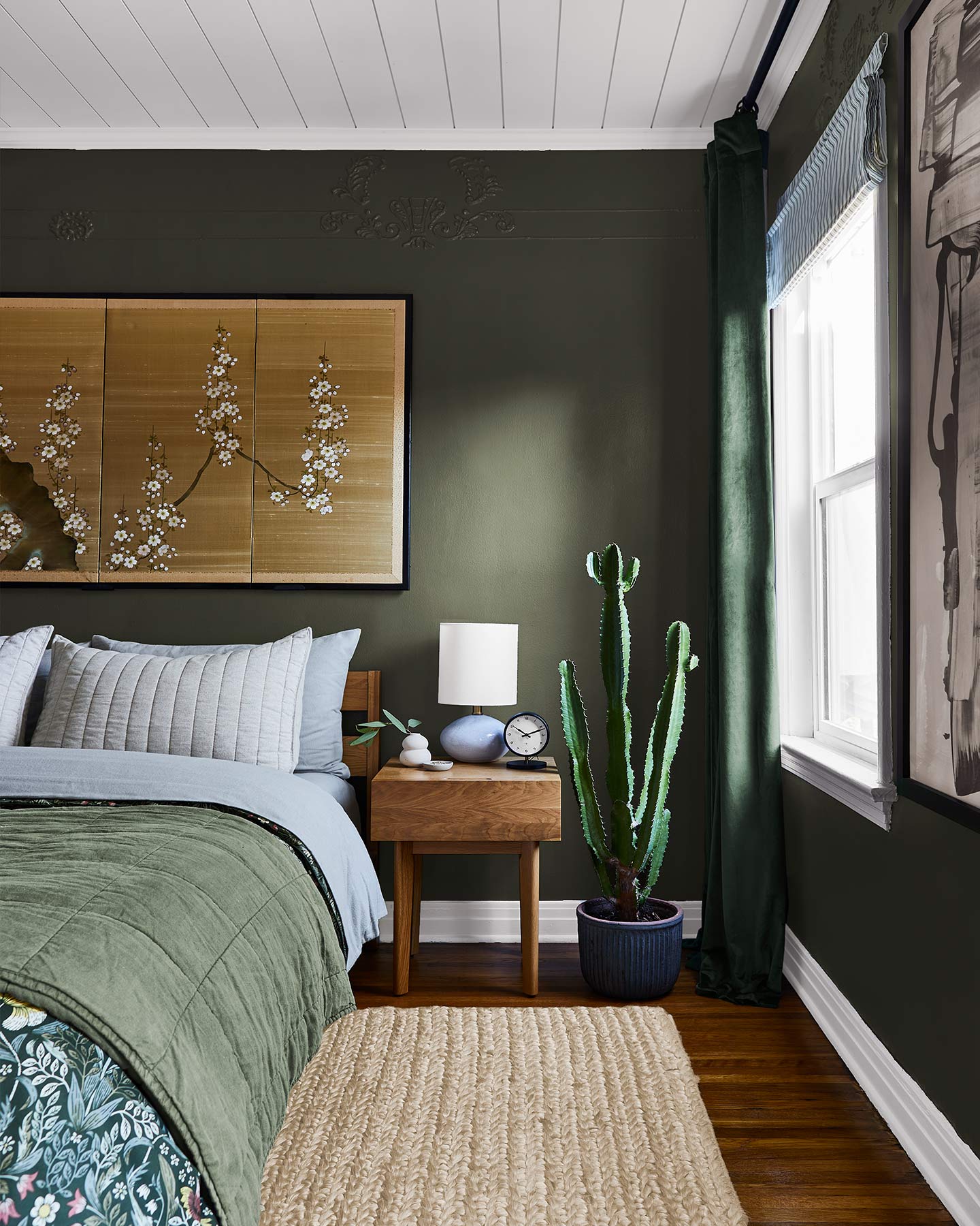 Cozy, unexpected, stylish--this dark green bedroom is a total showstopper.