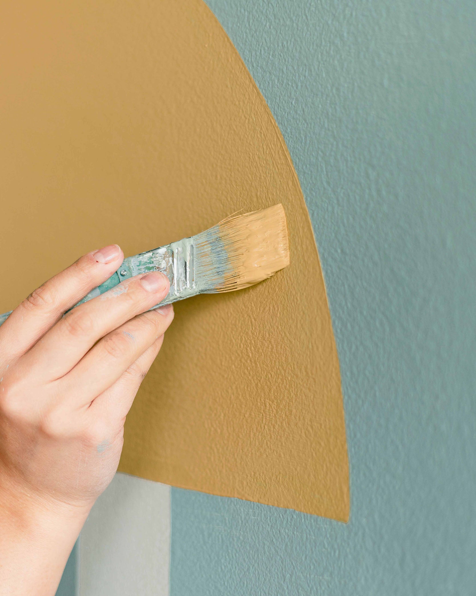Make sure to use the right brushes when creating your own geometric accent wall.