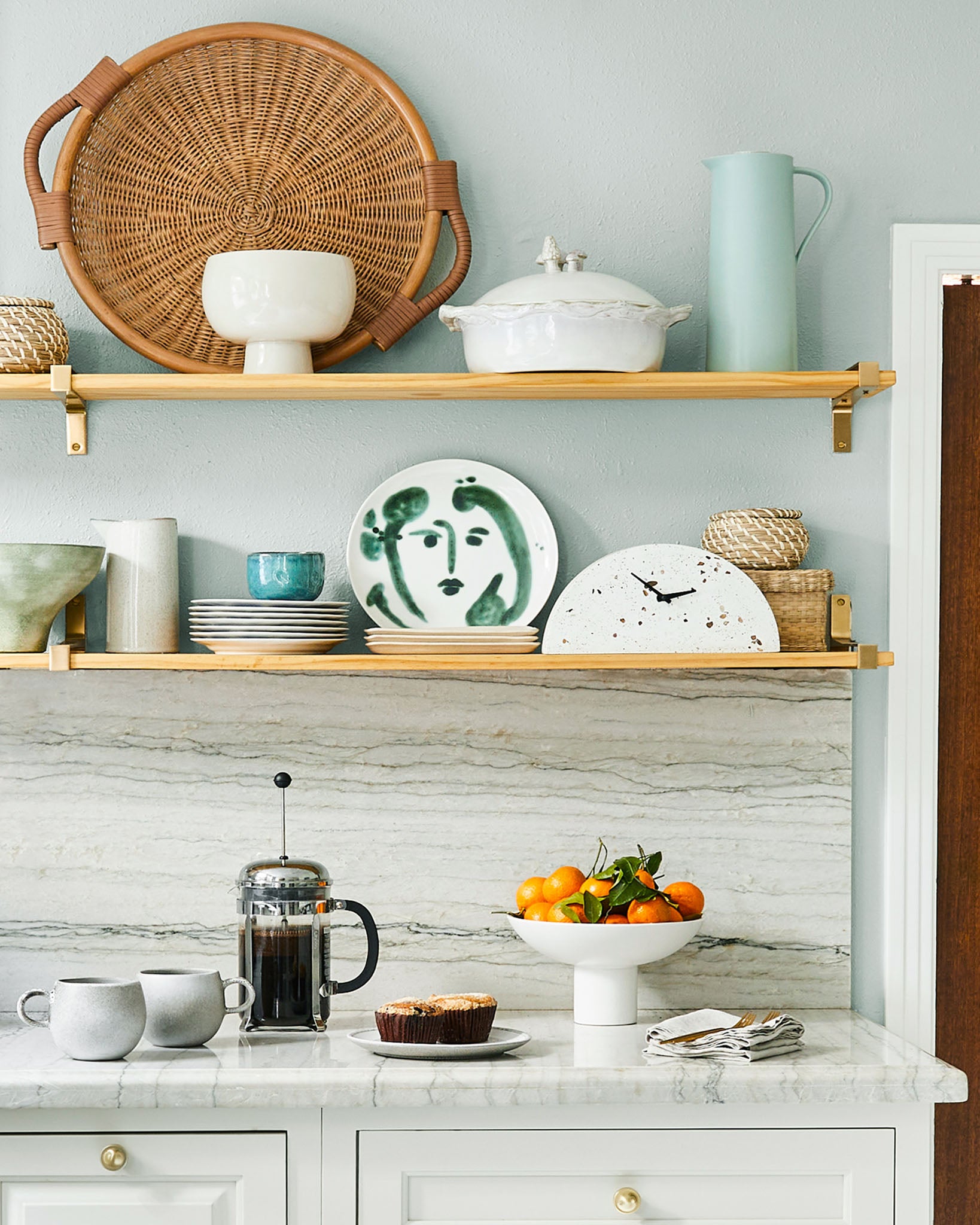 Go for floating shelves rather than pricey upper cabinets for a budget-friendly kitchen reno.