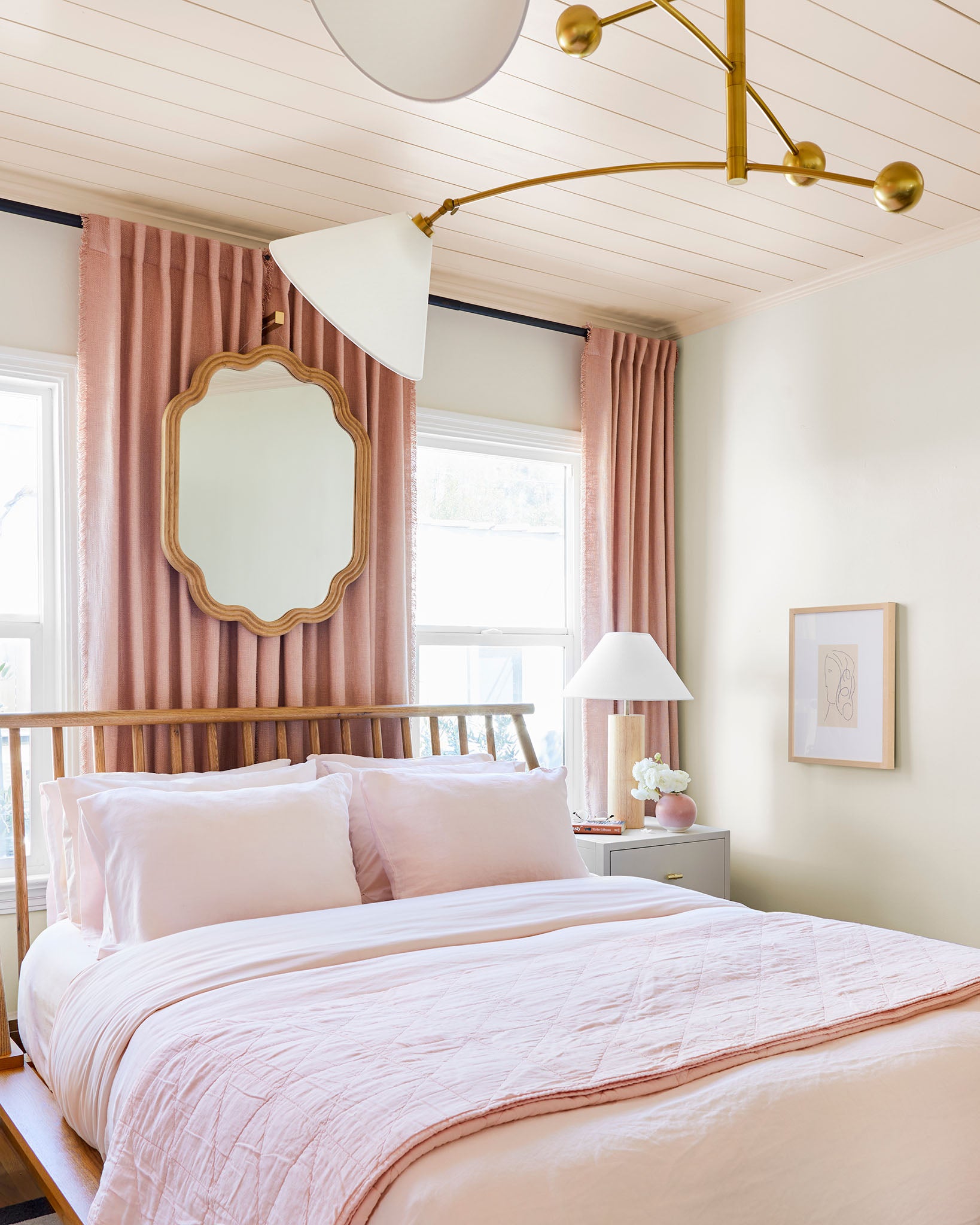 Piling on pink textiles, in addition to painting the ceiling a color, creates an intentional look.