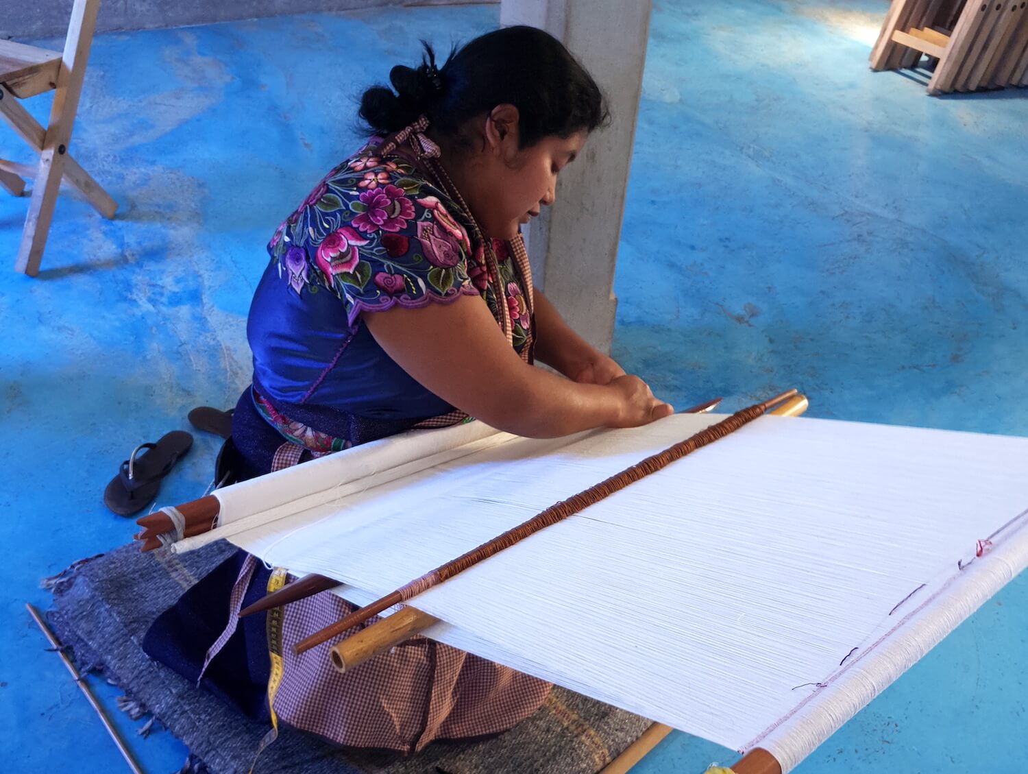 Artisan doing backstrap weaving