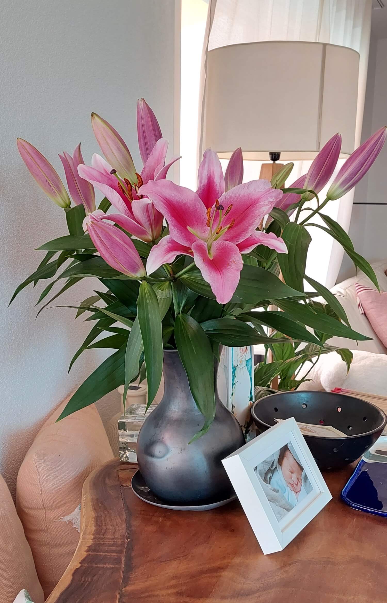 Black clay vase with flower arrangement for mom