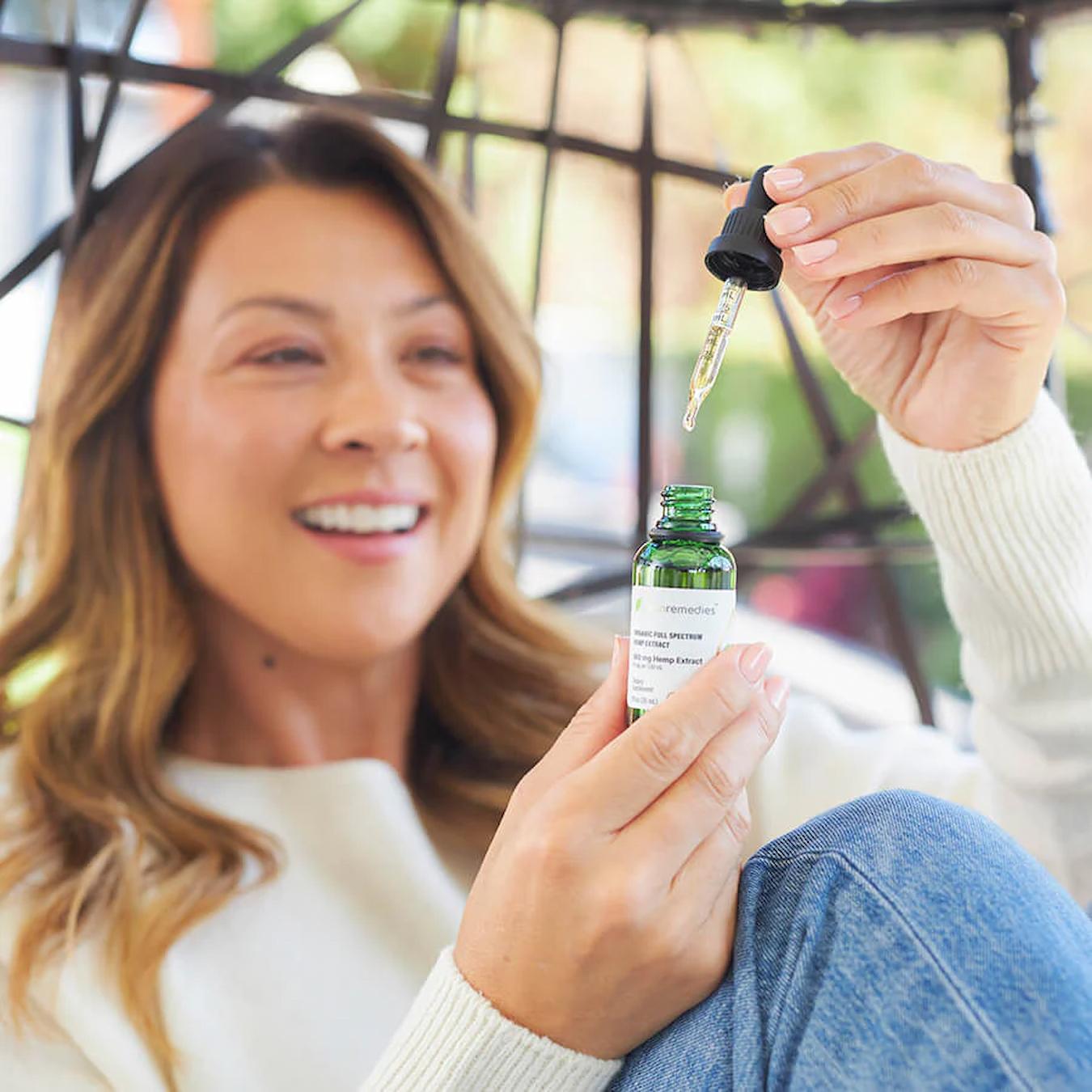a girl using a dropper bottle cbd for energy other energy boosting ingredients more energy