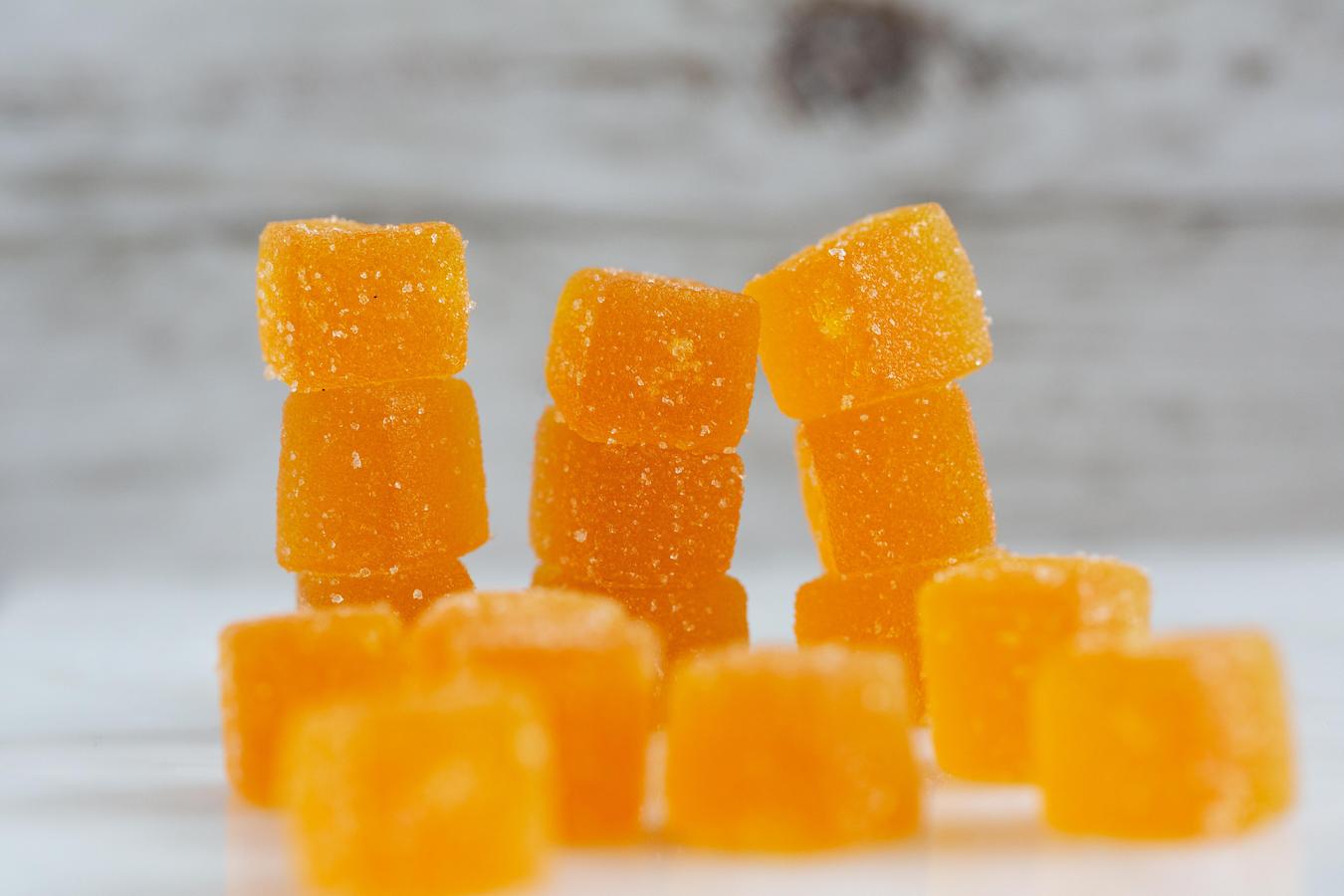 a pile of orange gummy candies cannabis infused oil cannabis tinctures fruit juice homemade edibles infused gummies potent weed gummies cannabis plant flavored jello
