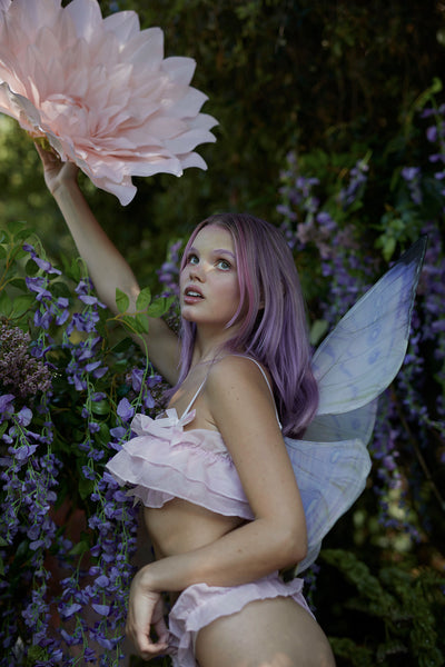 A fairy in the forest wearing the Midsummer Lilac Floating wings
