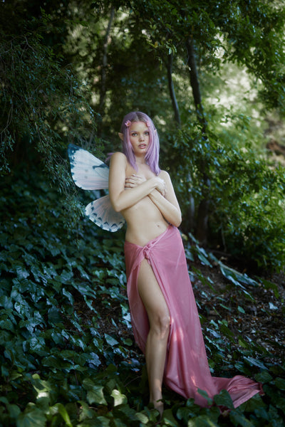 A fairy in the forest wearing the strapless Rosewater Pink fairy wings