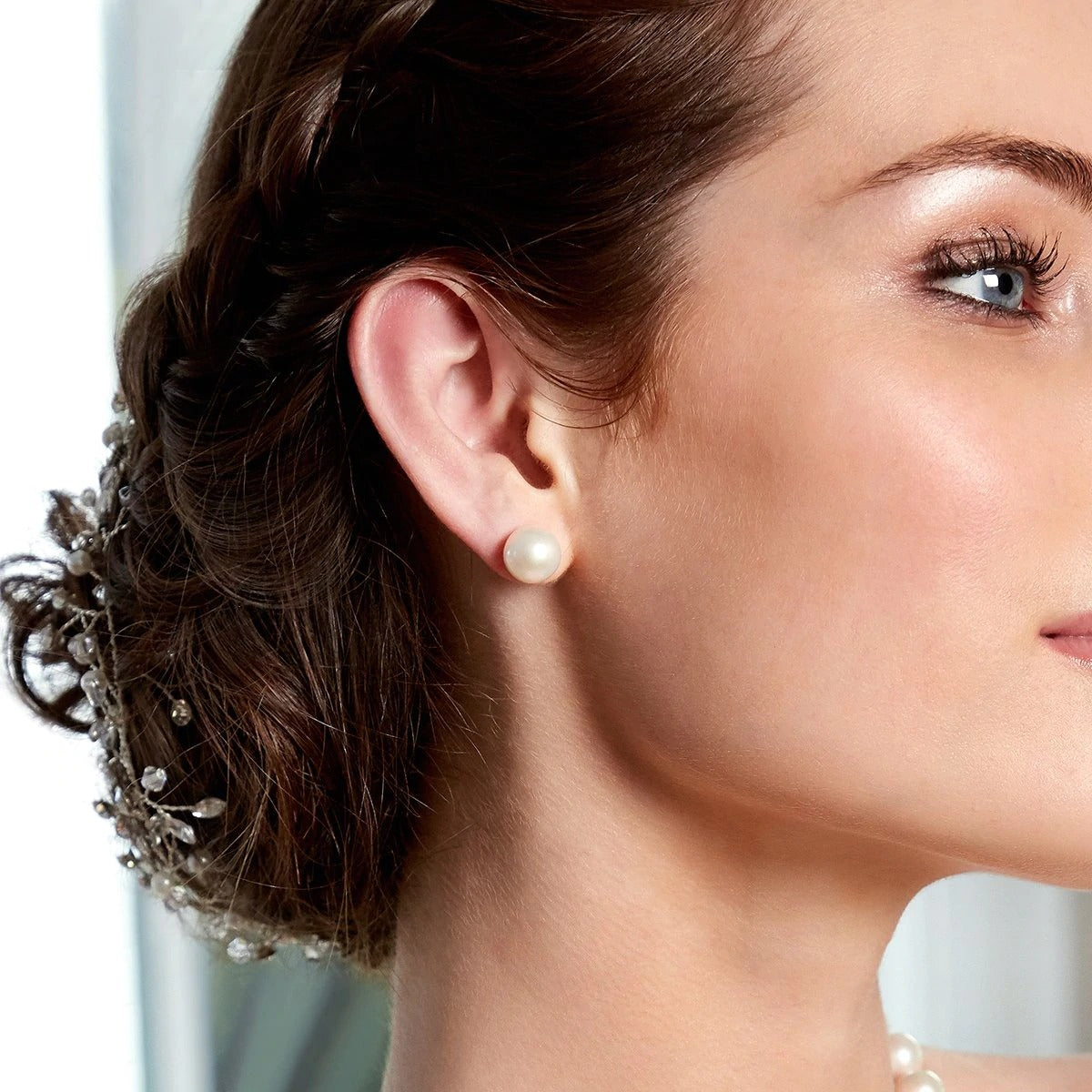Right side of model's face wearing the 9mm White Freshwater Round Pearl Stud Earrings