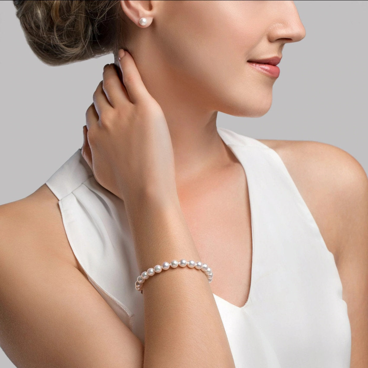 Model wearing White Japanese Hanadama Akoya Pearl Bracelet in 6.5-7.0mm from Pure Pearls