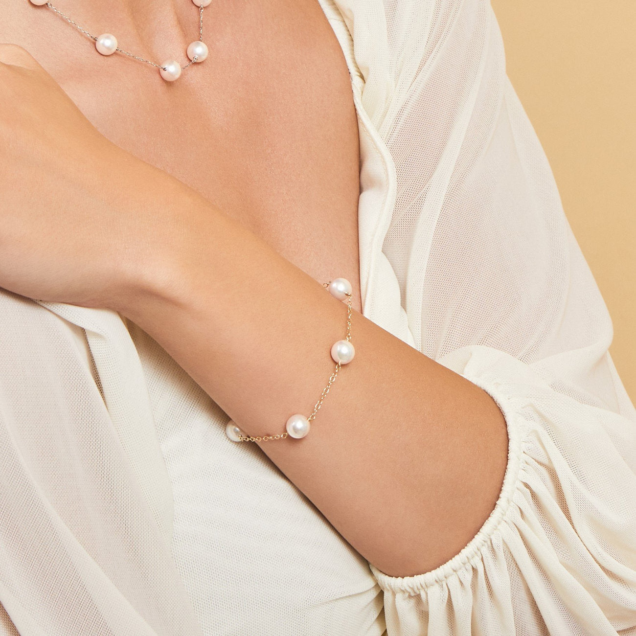 Model wearing Japanese Akoya White Pearl Tincup Bracelet from Pure Pearls