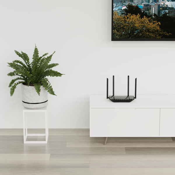 A view of a living room and a wi-fi router placed on top of a living room console