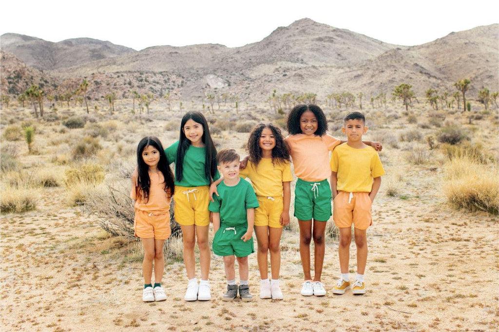 Kids wearing orange yellow and green clothes