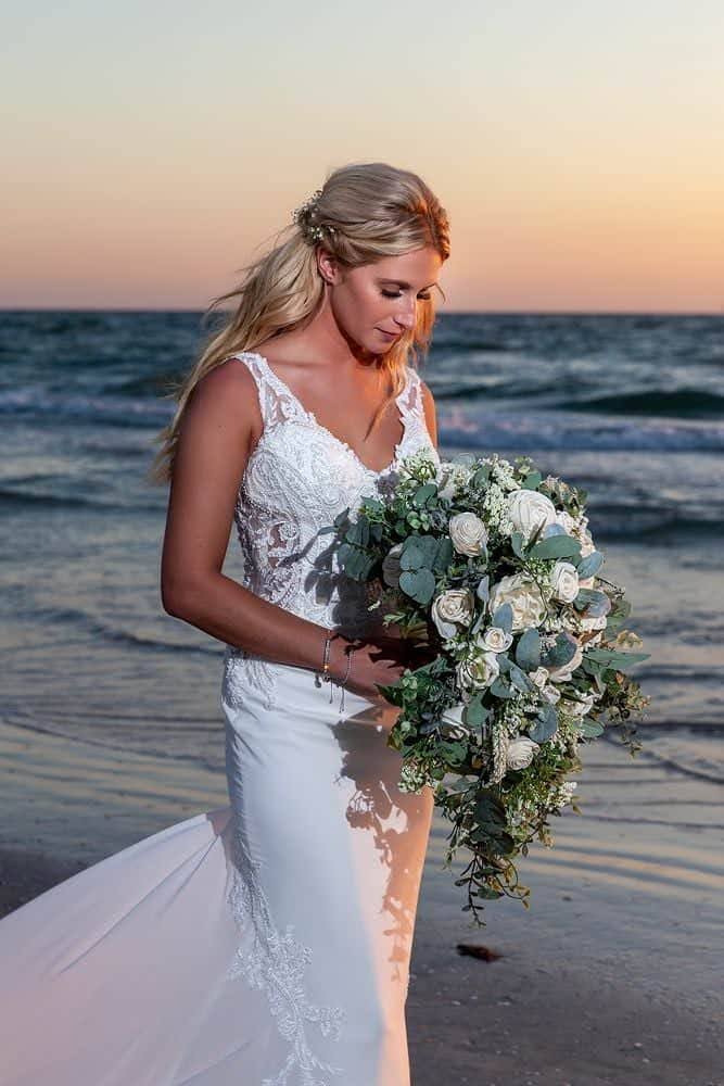 Ivory wood flower cascading bouquet on the beach of a destination wedding bouquet by North Wood Blooms LLC