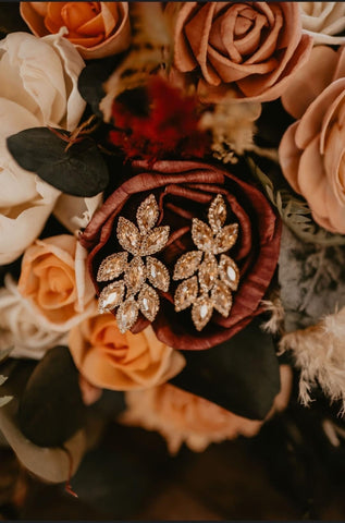 detail shot of wedding earrings next to a wood flower wedding bouquet by north wood blooms llc 