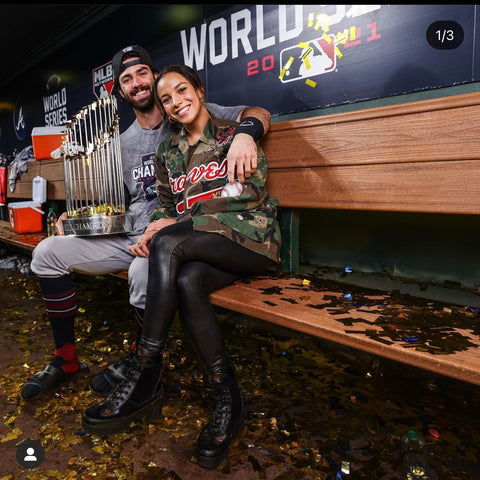 Mal Pugh wears camo jacket braves uniform at the braves World Series with boyfriend Dansby Swanson