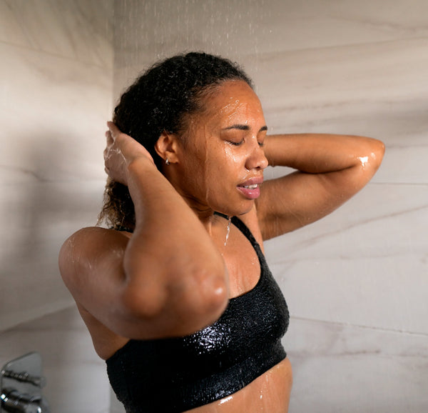 Woman washing hair in shower