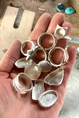 a handfull of partially finished silver rings