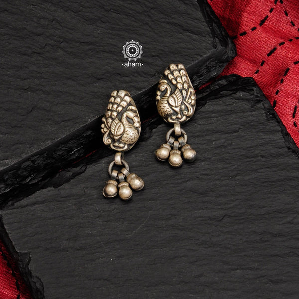 Mewad peacock earrings with intricate floral work. Handcrafted in 92.5 sterling silver with dangling ghungroos. An ode to the glorious state of Rajasthan. 