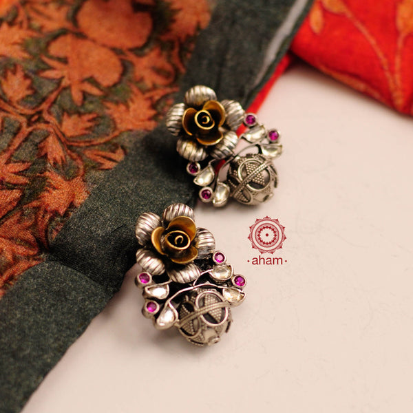 Noori two tone ball drop earrings in 92.5 sterling silver. Handcrafted with semi precious stone setting and a beautiful blooming flower stud. Style this up with your favourite ethnic or fusion outfit to complete the look.