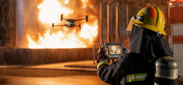 A firefighter flying the DJI Matrice 30T in response to a structural fire