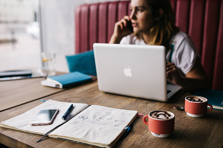 Woman working on a laptop in a café