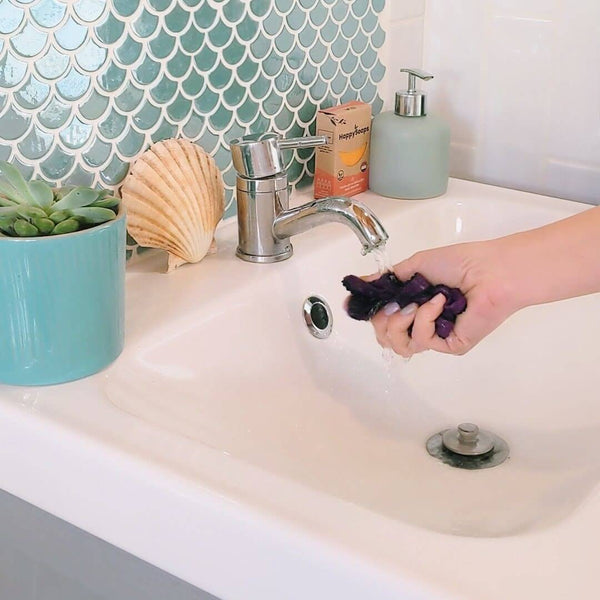 Underwear being hand washed in a sink