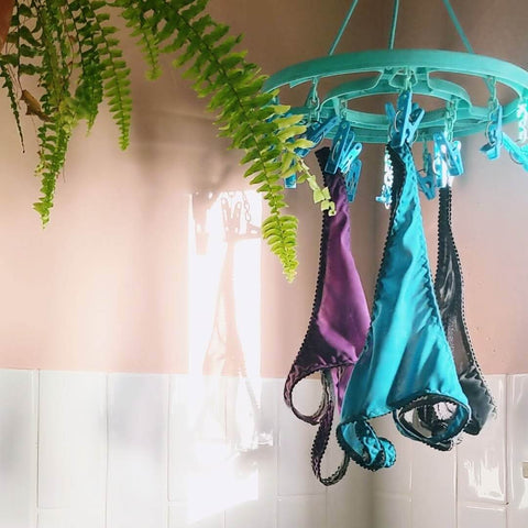 Underwear hanging up and air-drying next to a window