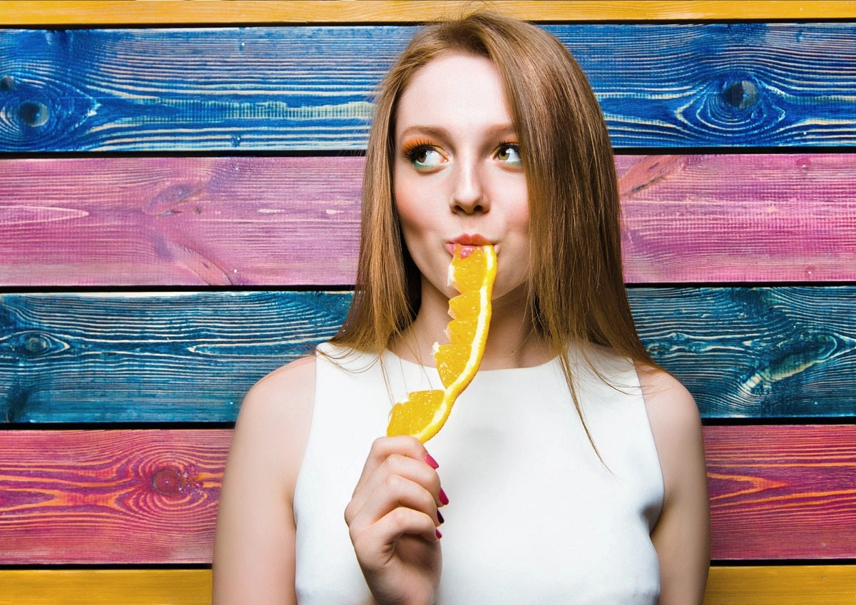 Girl eating a slice of orange