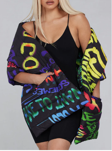 MODEL WEARING A MULTI PRINT AND COLOR QUILTED PONCHO SCARF
