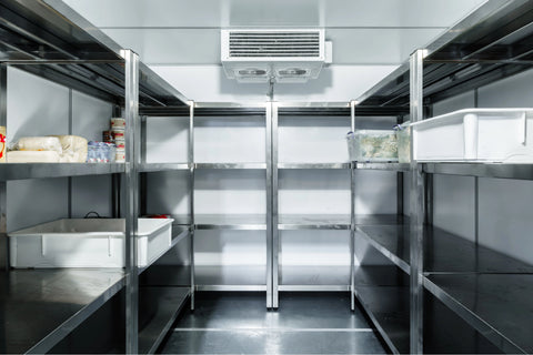 inside an industrial commissary freezer with metal shelving