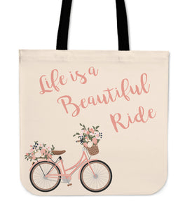 Pink bicycle and pink words stating life is a beautiful ride tote. Makes a great grocery, book, or beach bag.