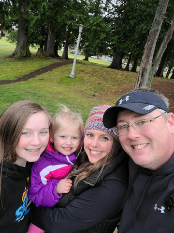 Family photo outdoors. Two girls, a woman and a man.