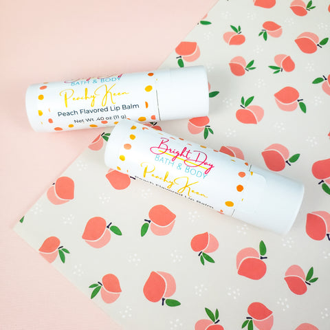 Two Peachy Keen Lip Balms on a decorative background