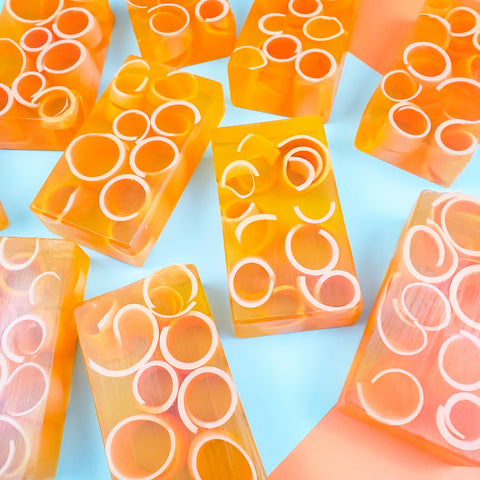 Orange bars of soap with light orange curls inside