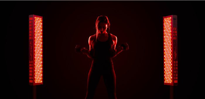 woman using red light therapy device