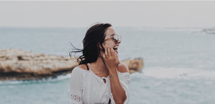 woman smiling by the ocean