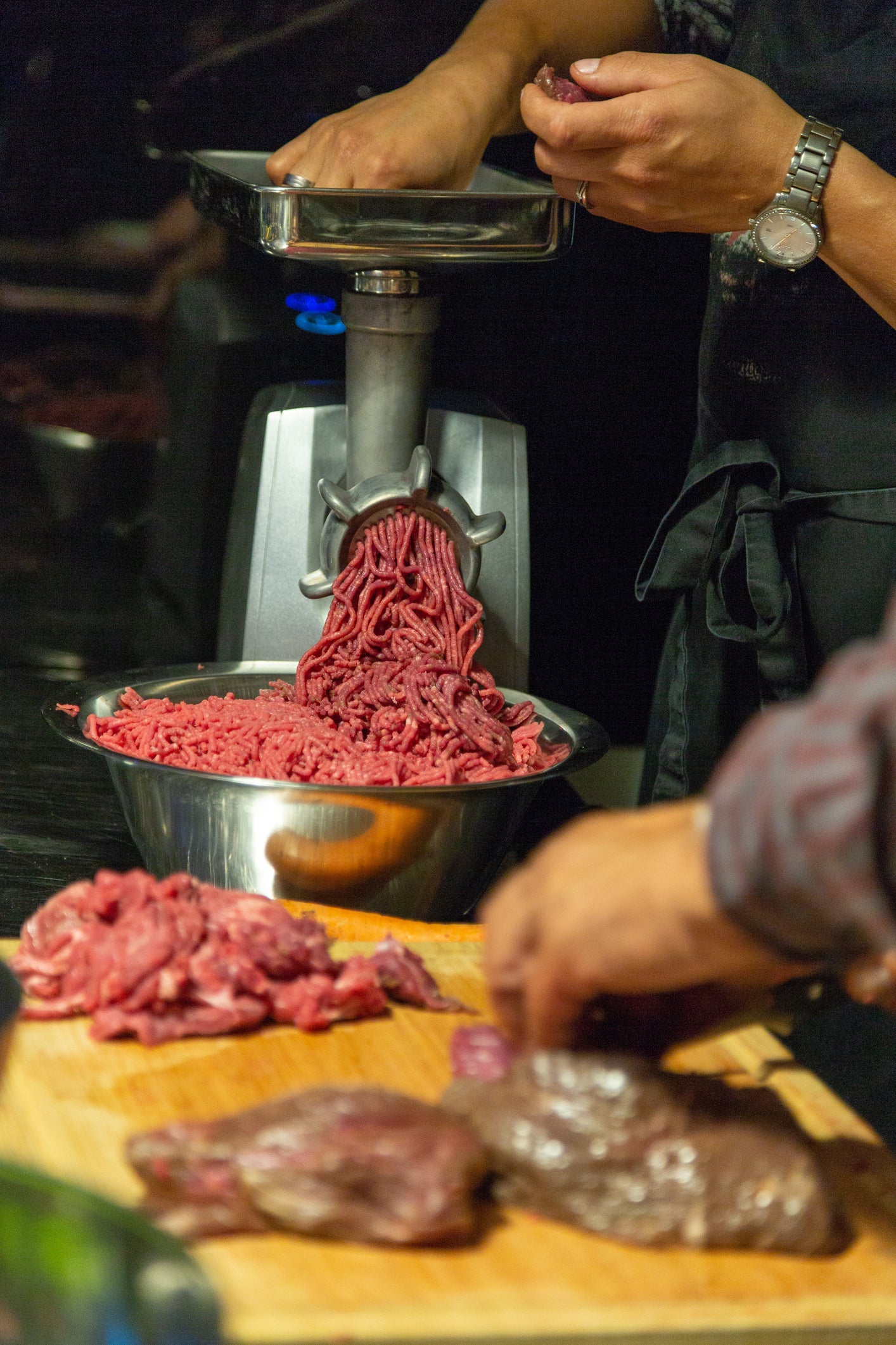 A commercial meat mincer with a table-top style of installation