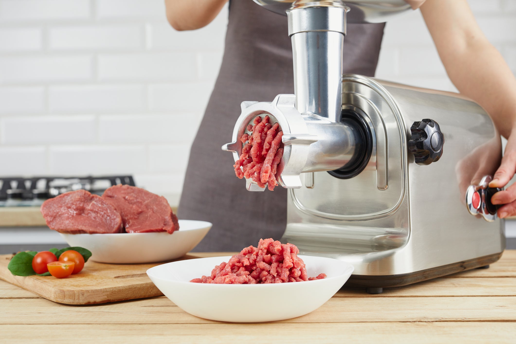 An electric mincer pushing out minced meat with ease