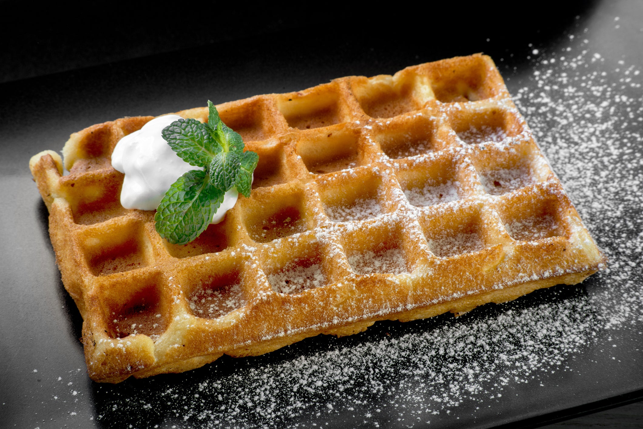 Brussels waffle garnished with mint and cream