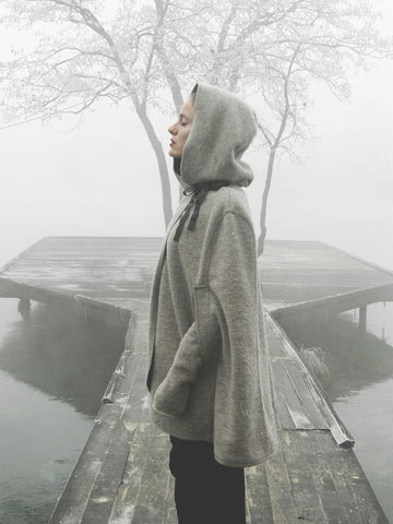 Peaceful woman standing on a dog in foggy weather 