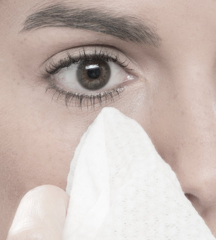 Brown-eyed woman using Ogee Organic Daily Facial Cleansing Cloth to remove makeup