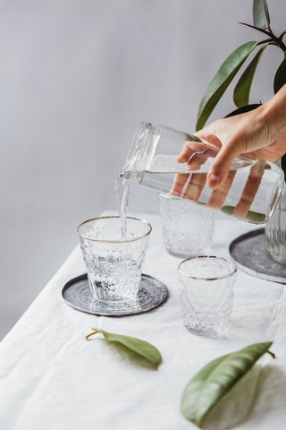 Clean Water being Poured into Crystal Glasses