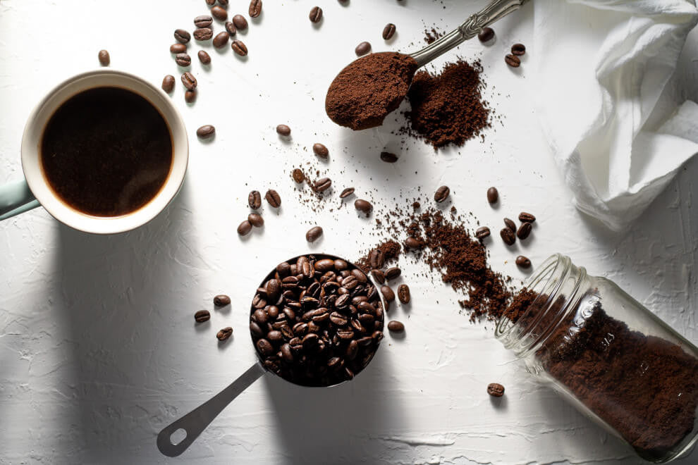 cacao powder and coffee beans on a white background