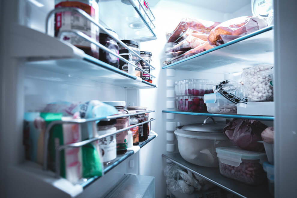 an open fridge with all the shelves occupied 